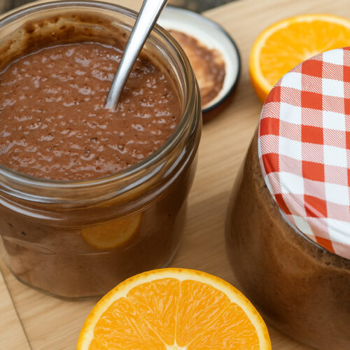 Schokoladen-Orangen-Pudding im Glas mit Orangenscheiben